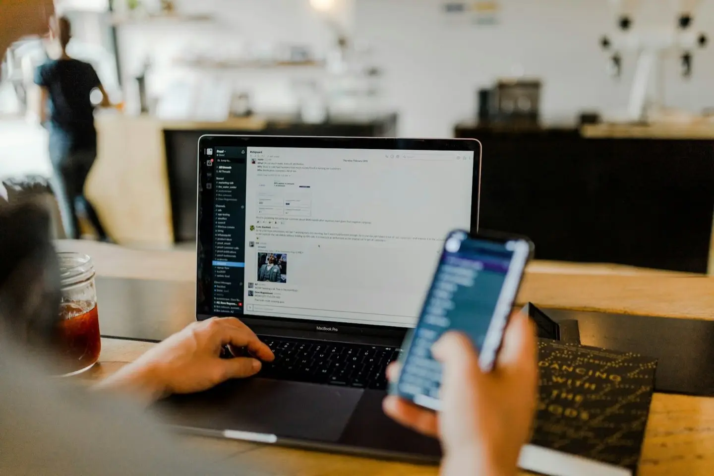 Person with laptop and smartphone at a table – IT costs and licences at a glance