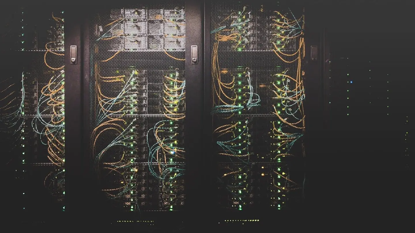Server racks with cabled systems and status lights – servers under monitored operation